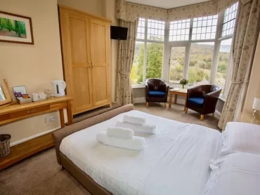 Bed in bedroom at The Sir William hotel in Grindleford, Peak District