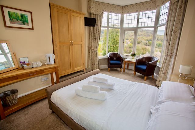 Bed in bedroom at The Sir William hotel in Grindleford, Peak District